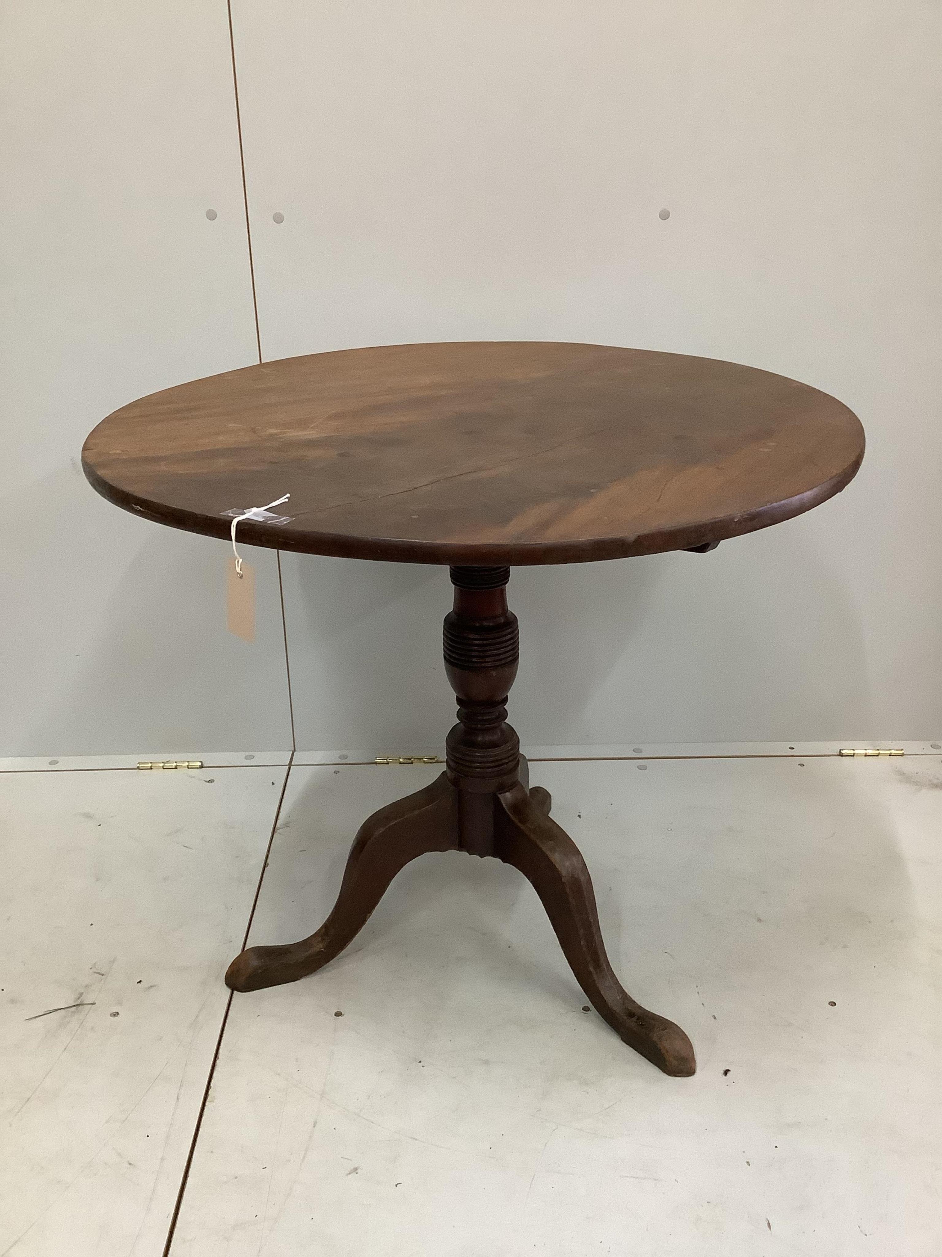 An early 19th century circular mahogany tilt top tripod tea table, diameter 84cm, height 72cm